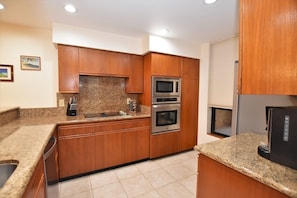 Kitchen features granite counter tops and new appliances.