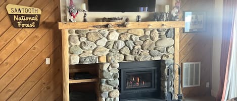 River rock gas fireplace has temperature controlled remote.