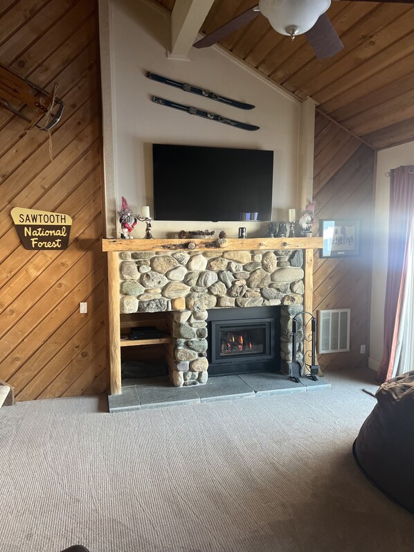River rock gas fireplace has temperature controlled remote.