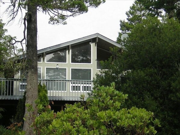 South side of house is all windows onto wraparound deck, grill, table & chairs