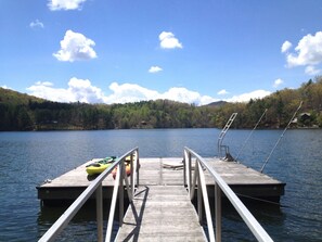 The dock with 4 kayaks and jet ski whips on right. Dock is 20x20 & ramp is 25 ft