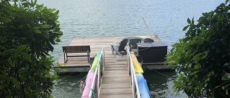 Dock with 4 Kayaks and jet ski whips on the right. Dock  20 x 20 with 25ft ramp