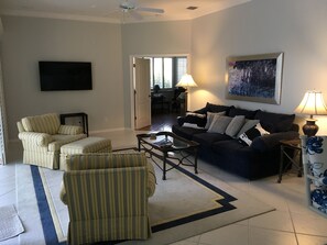 Main living area , sliding doors open to lanai on one wall , flat screen HDTV , 
