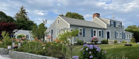 Main house, a garden of many hydrangeas and a very well manicured yard