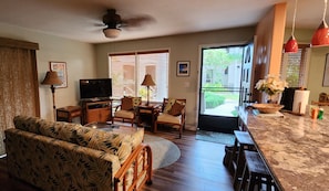 Living area looking toward entrance. Breakfast bar and kitchen to the right