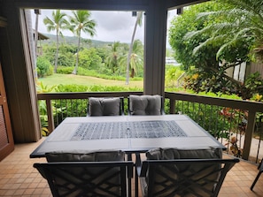 Ocean side lanai with comfortable outside dining/seating.