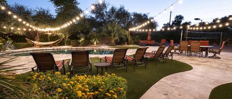 Backyard view from kitchen patio. Newly added string lighting.