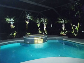 An evening in the hot bubbling spa under the romantic lighting around the pool.