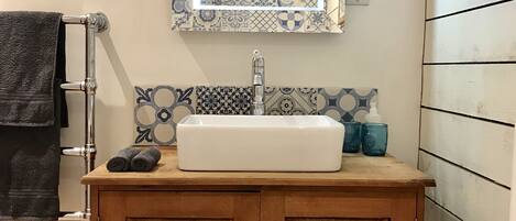A quirky country bathroom with a very deep bath. Soaps by Oast & Rye.