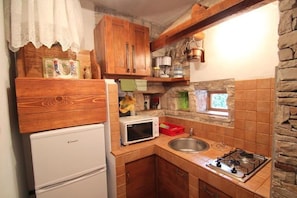 The kitchen with stove, microvawe, and fridge