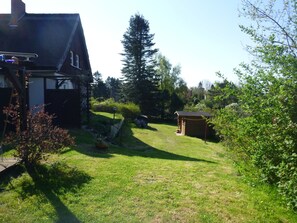 Blick in den Garten mit Kletterbaum und großzügigen Freiflächen