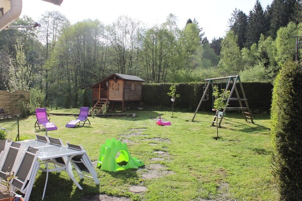 extérieur aménagé
avec cabane  et balançoire.