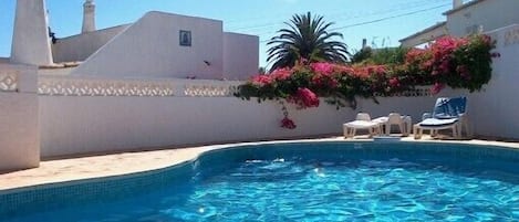 Swimming pool, villa in the background