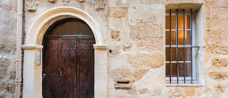 Our ancient building entrance door is a protected historical piece of monument.