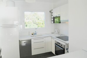 kitchen, sink and back view over trees