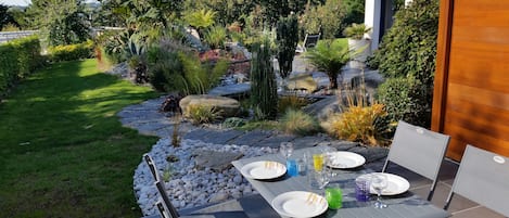 Terrasse avec table de jardin, barbecue et transats