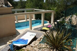 The pool is surrounded by trees