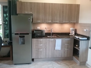 Fully equipped kitchenette with outdoor cooking area to keep the heat out