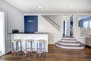Front door, living room with sofa and 3 person bar