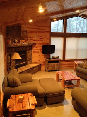 Cozy Living Room seating, wood fireplace, TV and floor to ceiling windowed views