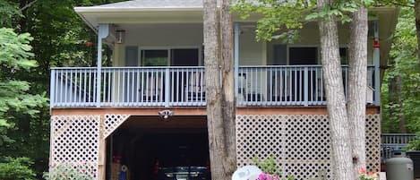 Front of house in summer showing covered parking.