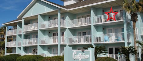 Corner unit in front building with view of beach.