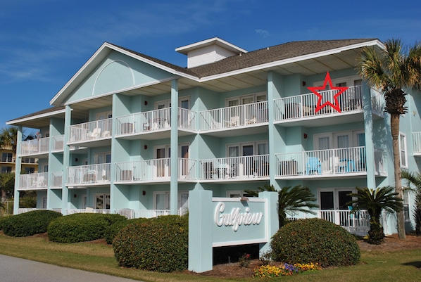 Corner unit in front building with view of beach.