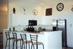 Eat-in kitchen with large breakfast bar and fully applianced