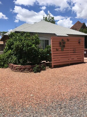 Grape trellis and distant view  of privacy wall.