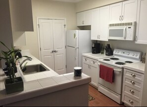 Full kitchen with stove, microwave, toaster oven, refrigerator, etc.