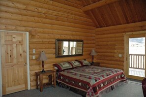 Master bedroom with king bed and vaulted ceiling