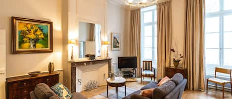 Salon bathed in light from windows overlooking the Chateau's Fortifications