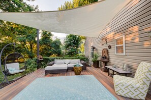 Large outdoor living room with shade sail.