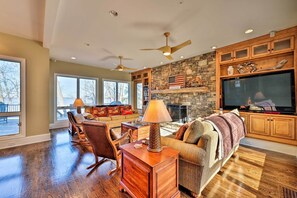 Roomy living area with huge stone fireplace and expansive lake views