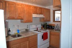 New small kitchen with a small washer/dryer. 