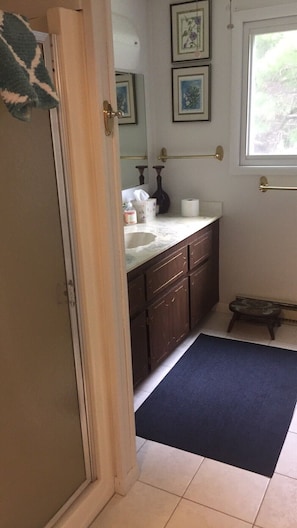 Bathroom on second floor with walk in shower and toilet.