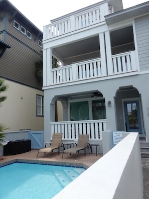 View of pool and front of the house from the driveway