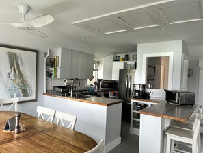The kitchen has and induction range and is fully equipped.