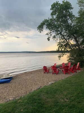 Adirondack chairs (8) around firepit on the beach near the creek (paddle boat)
