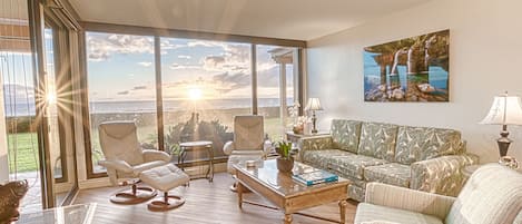 Living room with entrance to lanai and floor to ceiling windows!  Sunset wow!