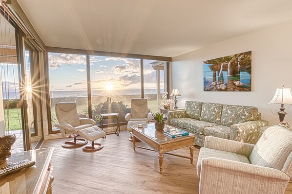 Living room with entrance to lanai and floor to ceiling windows!  Sunset wow!