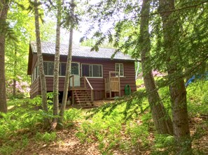 Rear view of cottage with back steps and outdoor shower