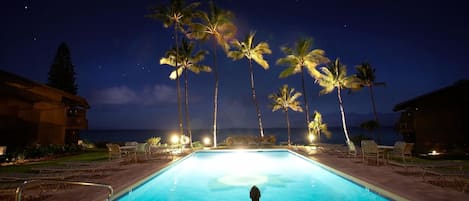 The beautifully lit pool at night.