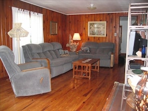 Living room area with original knotty pine floors and walls