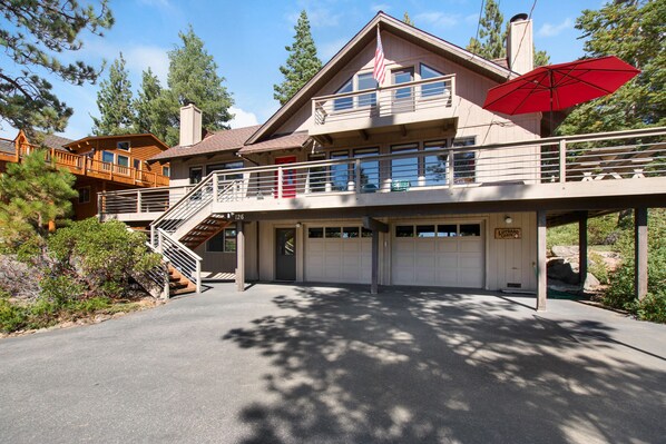 Front of cabin with driveway, 2 car garage and front decks