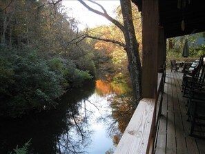 Main deck has rocking chairs, swing, gas grill, hot tub, & outdoor tbl on stream