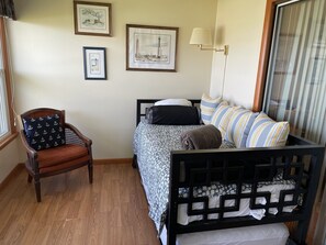 Day bed in sunroom can serve as second bedroom. Trundle underneath adds a bed.