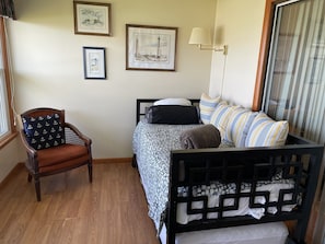 Day bed in sunroom can serve as second bedroom. Trundle underneath adds a bed.