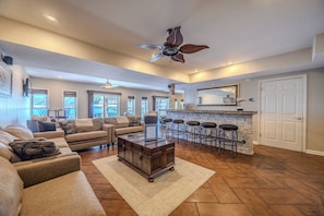 This spacious living room with a cozy bar area is perfect for entertaining.