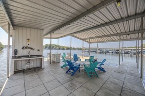 Relax in style on this spacious covered dock, perfect for lakeside lounging.
